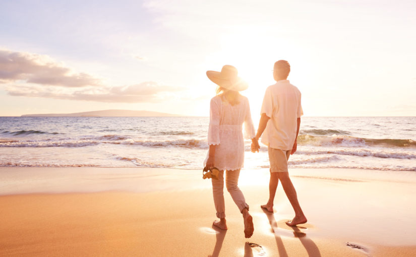 49643713 - happy romantic middle aged couple enjoying beautiful sunset walk on the beach. travel vacation retirement lifestyle concept